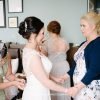 Bride preparing with family at wedding ceremony.