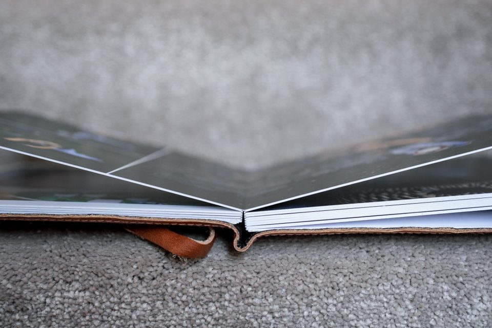 Open photo book on carpet.