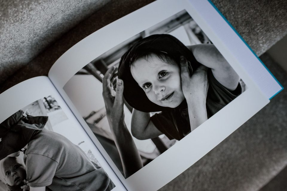 Black and white photo of child in book.