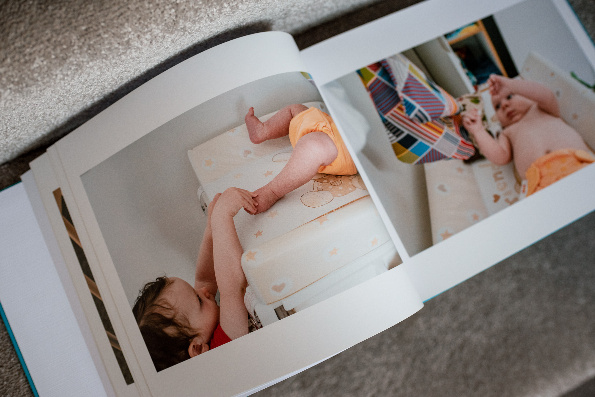 Photo album open to baby pictures.