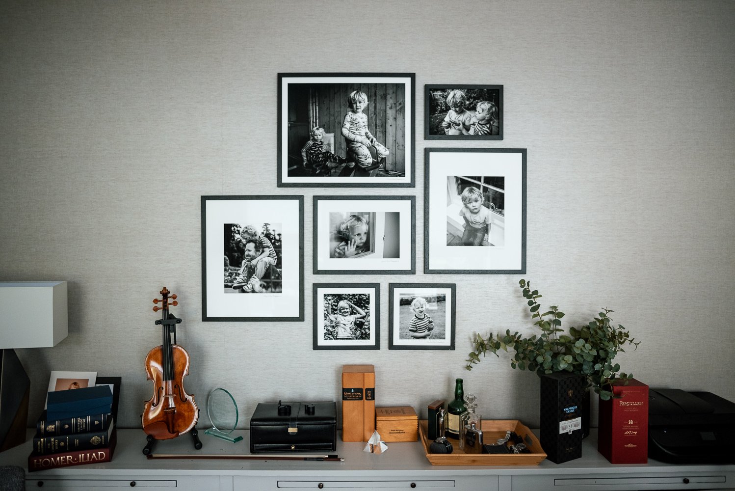 Wall display of framed black and white family photos