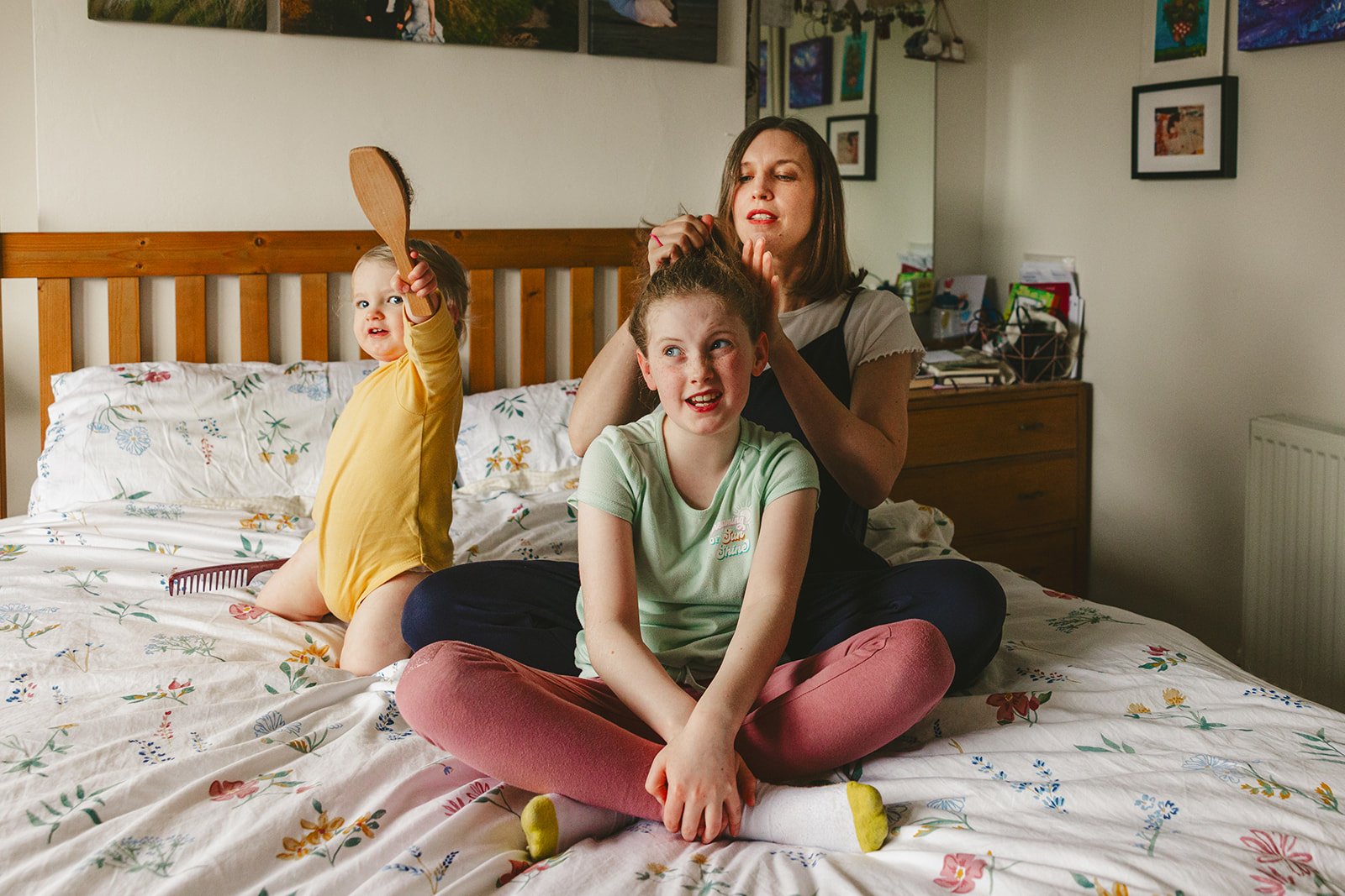 Family enjoying family time on bed at home.